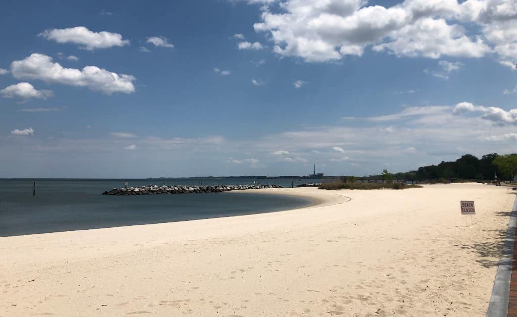 Large white sandy beach next to a body of water